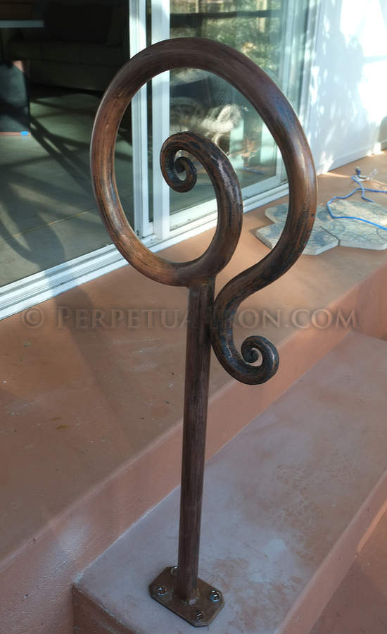 Hand forged custom fabricated single post railing for a couple of steps.